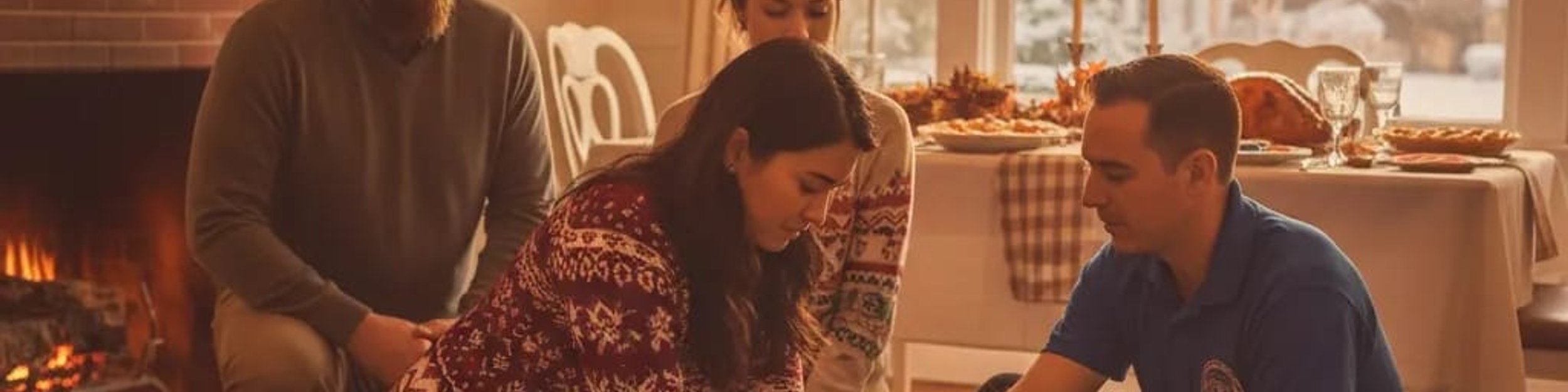 Family practicing CPR on a manikin with an instructor in a living room set for Thanksgiving